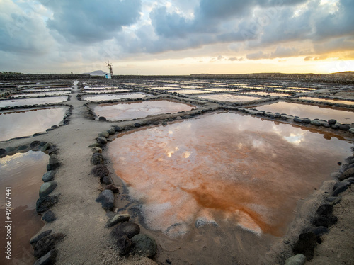 Ponds of color at sunrise, salines of Tenefe, coast of Gran canaria, Canary islands photo