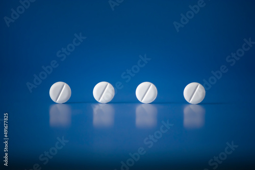 Concept of pills Men Women Kids Health on blue horizontal plane background Hight quality Photo. Fake medicine - placebo is a sham substance or treatment which is designed to have no therapeutic value photo