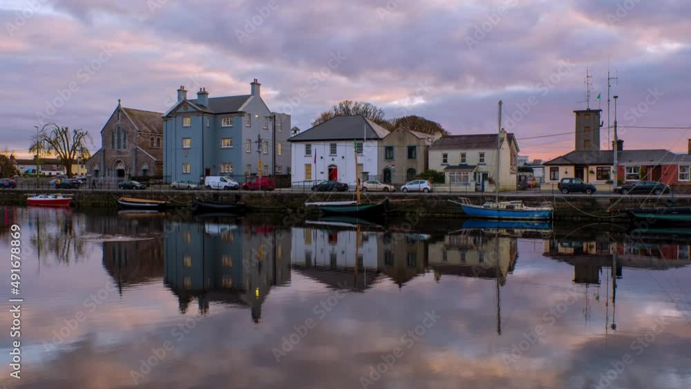 Galway, Ireland. Beautiful landscape of Galway, Ireland. River and famous painted houses with cloudy colorful sky. Time-lapse during the sunset, zoom in Galway, Ireland. Beautiful landscape of Galway, Ireland. River and famous painted houses with cloudy colorful sky. Time-lapse during the sunset, zoom in