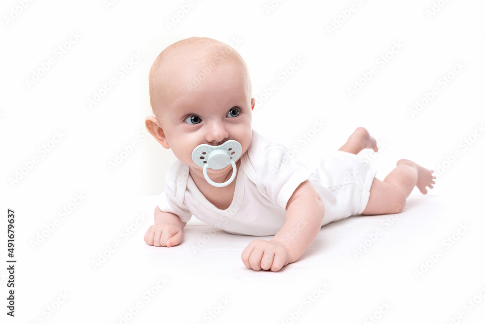surprised charming baby with a pacifier in his mouth on a white background surprised charming baby with a pacifier in his mouth on a white background