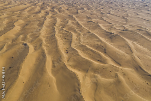 Aerial view of sand dunes in the desert at sunset, Dubai, United Arab Emirates. photo
