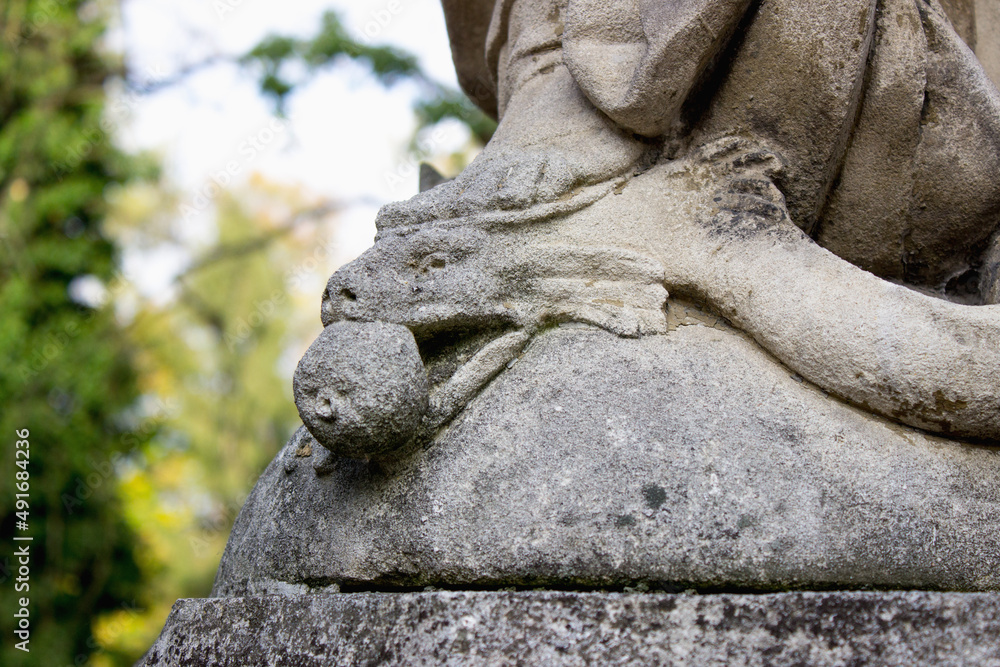 The snake is crushed by a woman's leg. Biblical story of the Virgin Mary and the devil The snake is crushed by a woman's leg. Biblical story of the Virgin Mary and the devil