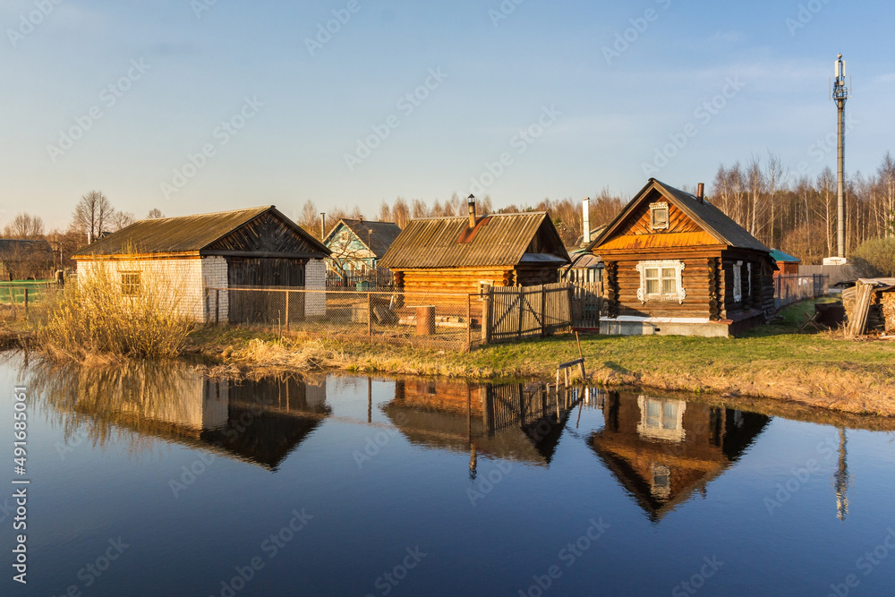 Village buildings on the shore of a reservoir