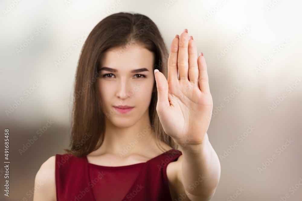 Young female extend hand with stop symbol gesture oppose against domestic sexual violence abuse racial gender discrimination. Young female extend hand with stop symbol gesture oppose against domestic sexual violence abuse racial gender discrimination.