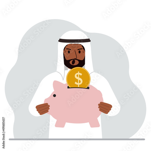 Screaming muslim man holds a piggy bank, a coin falls into the piggy bank. The concept of saving finance, savings, investing finances.