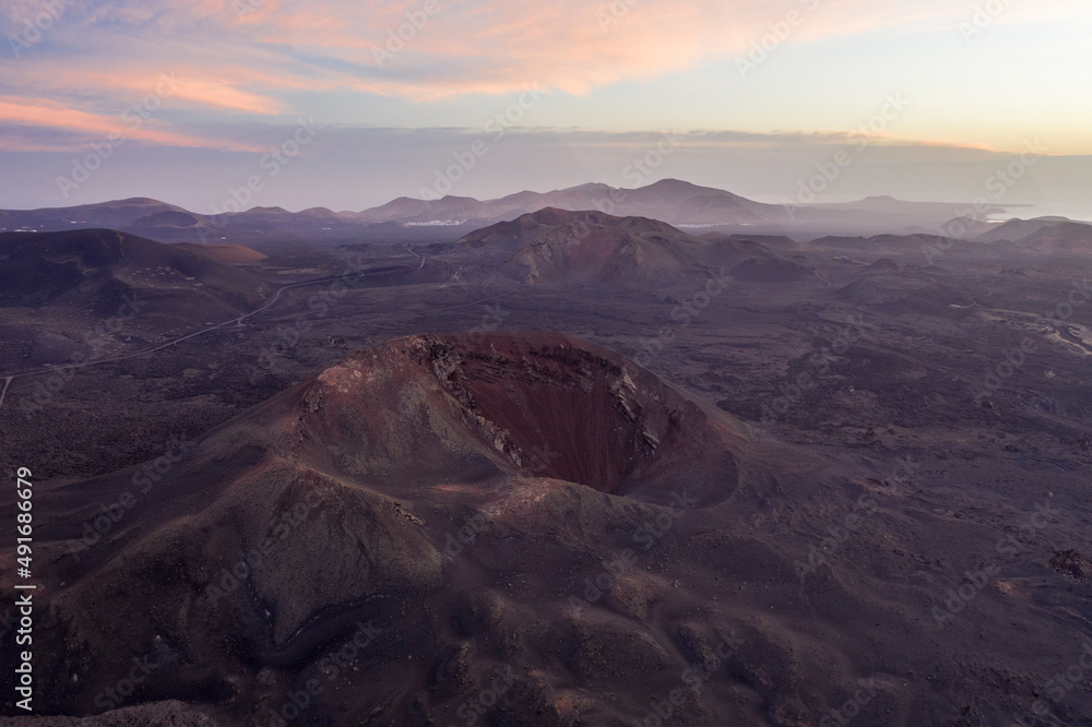 Aerial view of Caldera Blanca at sunset, a volcano on Lanzarote island, Canary Islands, Spain. Aerial view of Caldera Blanca at sunset, a volcano on Lanzarote island, Canary Islands, Spain.
