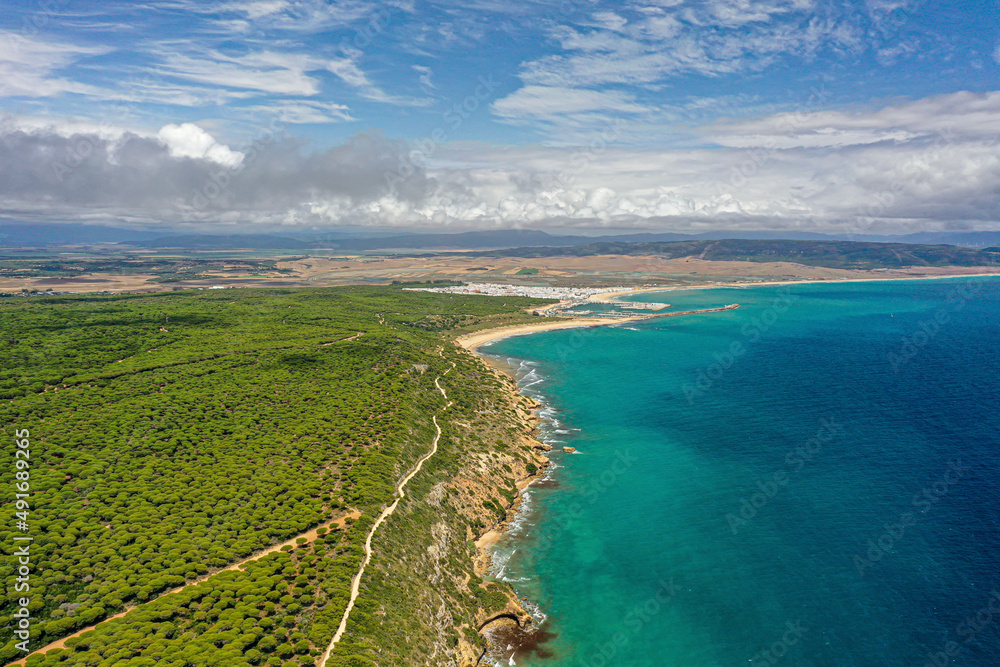 Aerial view of cliffs along the coastline with turquoise waters, Torre del Tajo, Barbate, Spain. Aerial view of cliffs along the coastline with turquoise waters, Torre del Tajo, Barbate, Spain.