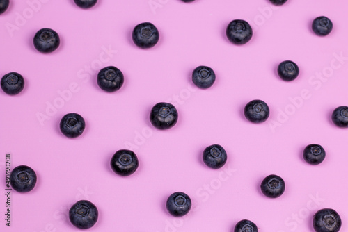 Colorful berries pattern. Blueberries on pink background. Flat lay, top view image.