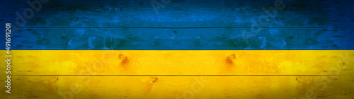 Ukrainian flag background banner panorama - old wooden boards, wood wall texture background, in the colors of the flag of Ukraine