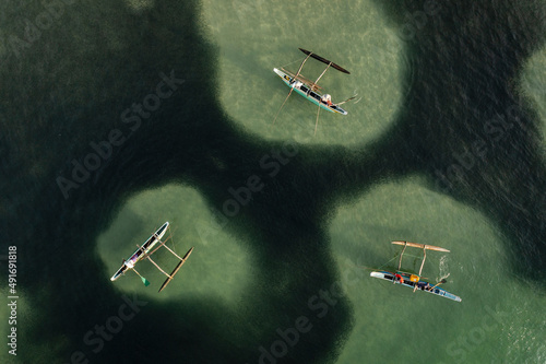 Aerial view of local fishermen in traditional wooden boats near Dickwella beach, Dikwella, Sri Lanka. photo