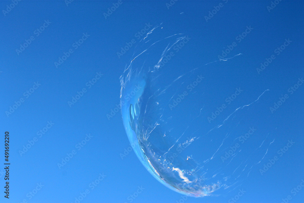 soap bubble burst against a clear sky soap bubble burst against a clear sky