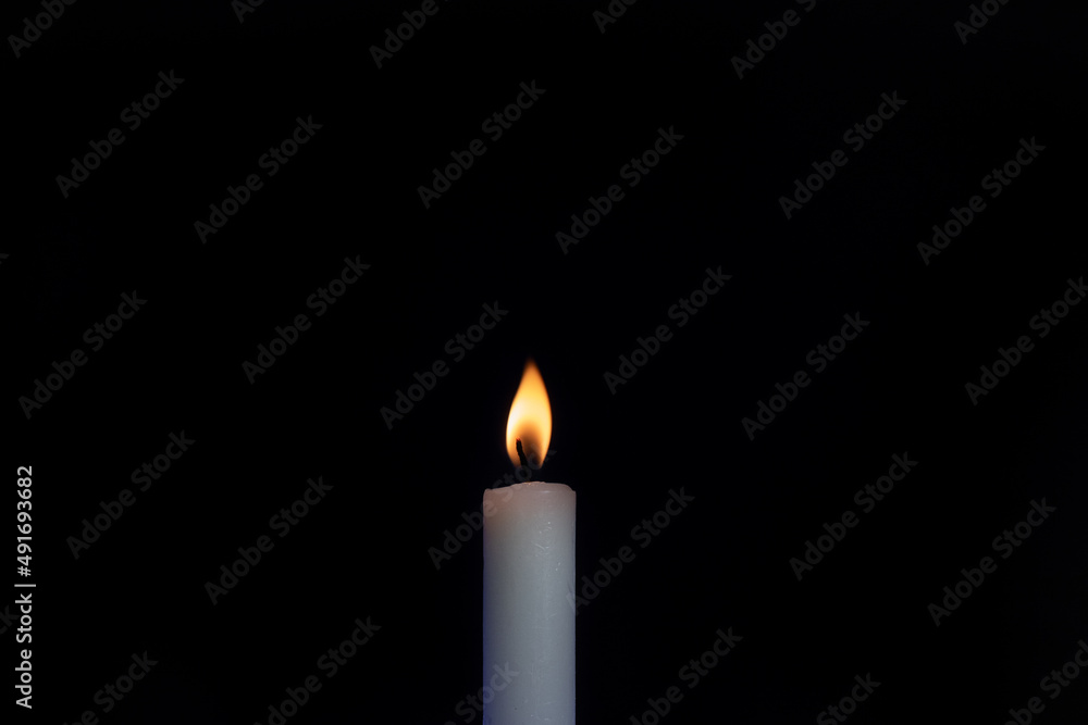burning candle on black background burning candle on black background