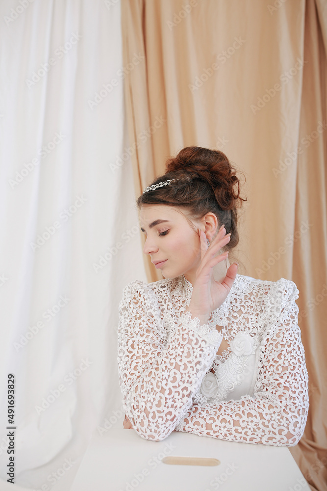girl in a white wedding retro dress. wedding dress and hairstyle in the style of the 90's. Studio photo shoot in my mother's wedding dress. Bride photo shoot in the studio girl in a white wedding retro dress. wedding dress and hairstyle in the style of the 90's. Studio photo shoot in my mother's wedding dress. Bride photo shoot in the studio