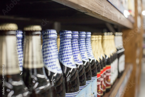 Bottles of beer on wooden shelves in supermarket