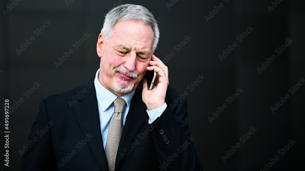 Senior manager on the phone looking happy