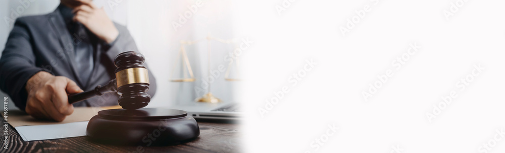 Male lawyer working with contract papers and wooden gavel on tabel in courtroom. justice and law ,attorney, court judge, concept.. Male lawyer working with contract papers and wooden gavel on tabel in courtroom. justice and law ,attorney, court judge, concept..
