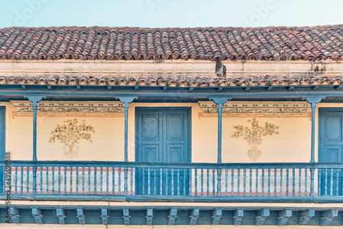 Sticker Big balcony with wooden railings of colonial Spanish style house in historic cen