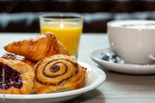 Continental breakfast of assorted pastries including croissant, Danish and cinnamon swirl served with coffee and orange juice
