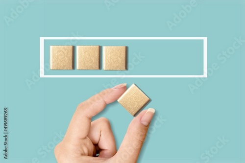 Hand putting wooden cube with shopping cart print screen on with infographic download for sale