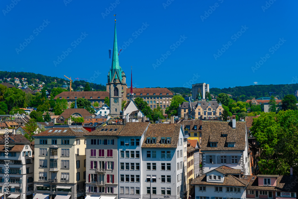 Panorama view on Zurich houses and Imperial Abbey of Fraumünster.  Shot taken from a rooftop on a sunny and hot summer day