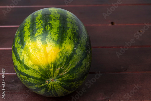 Close up view of watermelon isolated on wood background. Healthy food concept. 