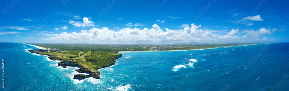 Macao beach with sandy coastline, turquoise water and stone cliff. Dominican Republic. Aerial panorama view - obrazy, fototapety, plakaty 