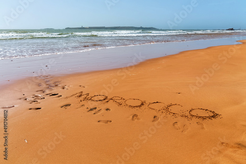 Morocco word is written on the sandy beach of the Atlantic ocean coast in Morocco.