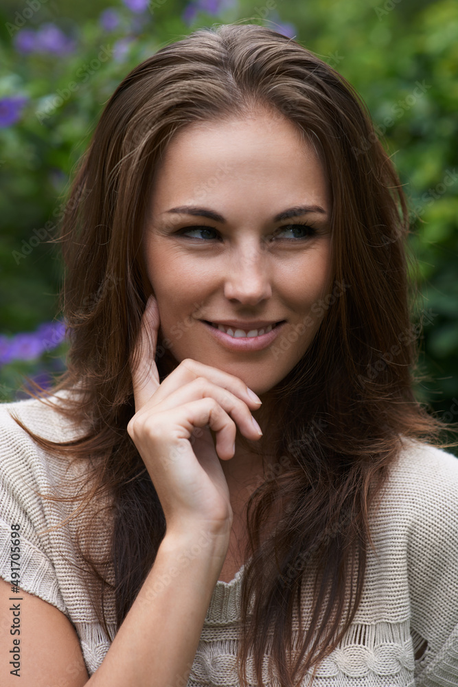 Thinking about the day ahead. An attractive young woman standing in the garden. Thinking about the day ahead. An attractive young woman standing in the garden.