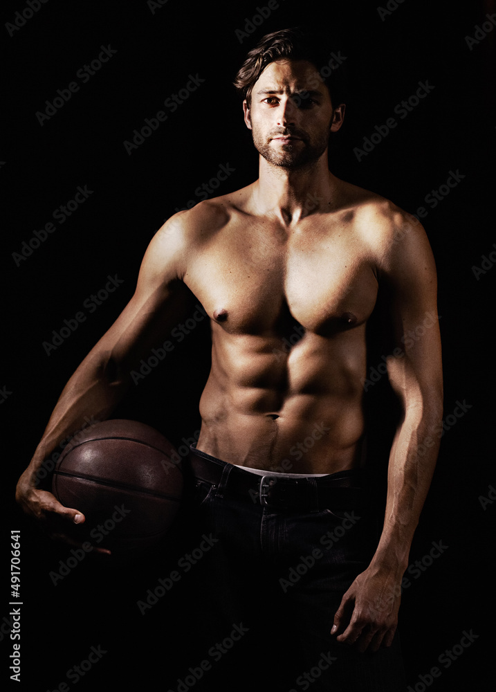 His skills and body are honed to perfection. Cropped image of a muscular young man holding a soccerball. His skills and body are honed to perfection. Cropped image of a muscular young man holding a soccerball.