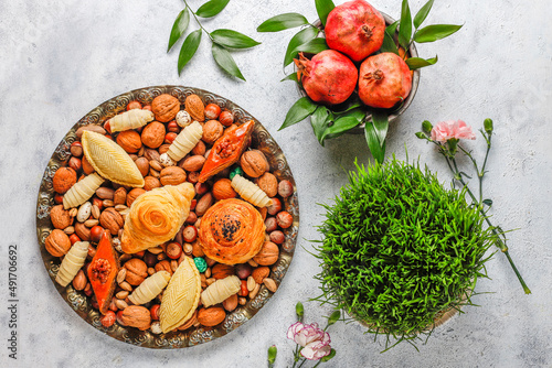 Traditional Azerbaijan spring holiday Nowruz tray with semeni - wheat grass, pakhlava, shekerbura,badambura,mutaki,gogal,flowers,dry fruits,spring flowers.