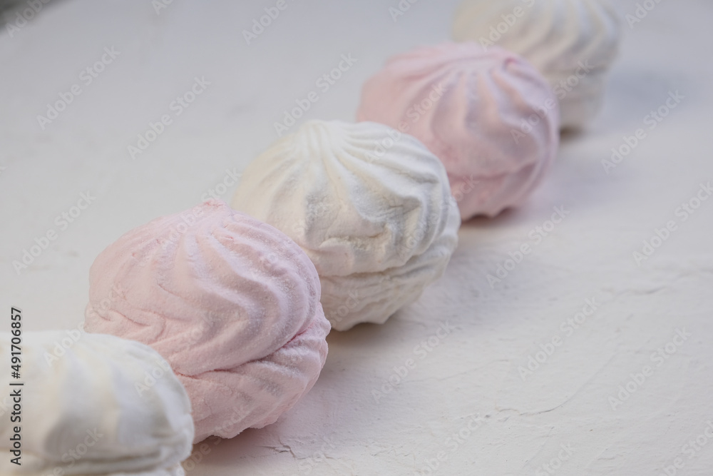 Marshmallow without packaging close-up on a white background. side view. Zephyr pink and white. Protein sweetness. Air dessert.
Marshmallow without packaging close-up on a white background. side view. Zephyr pink and white. Protein sweetness. Air dessert.