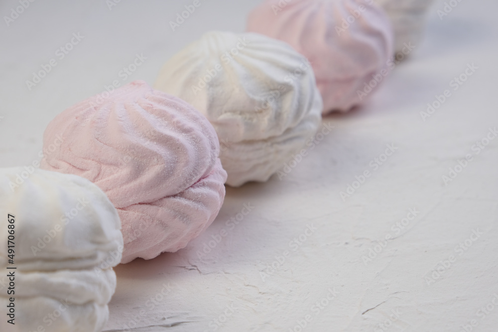Marshmallow without packaging close-up on a white background. side view. Zephyr pink and white. Protein sweetness. Air dessert.
Marshmallow without packaging close-up on a white background. side view. Zephyr pink and white. Protein sweetness. Air dessert.