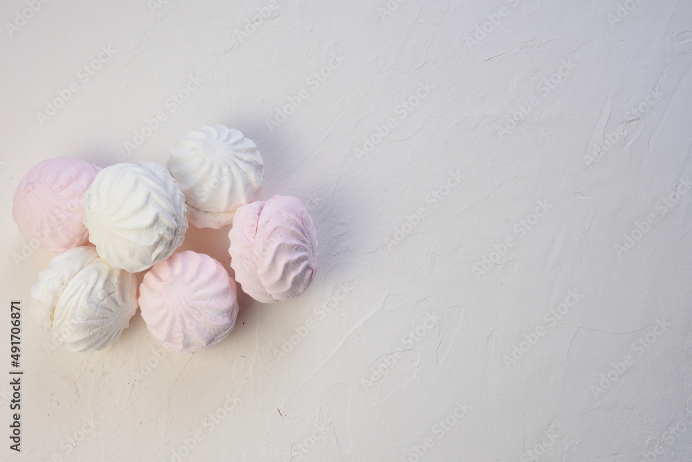 Marshmallow without packaging close-up on a white background. view from above. Zephyr pink and white. Protein sweetness. Air dessert. Marshmallow without packaging close-up on a white background. view from above. Zephyr pink and white. Protein sweetness. Air dessert.