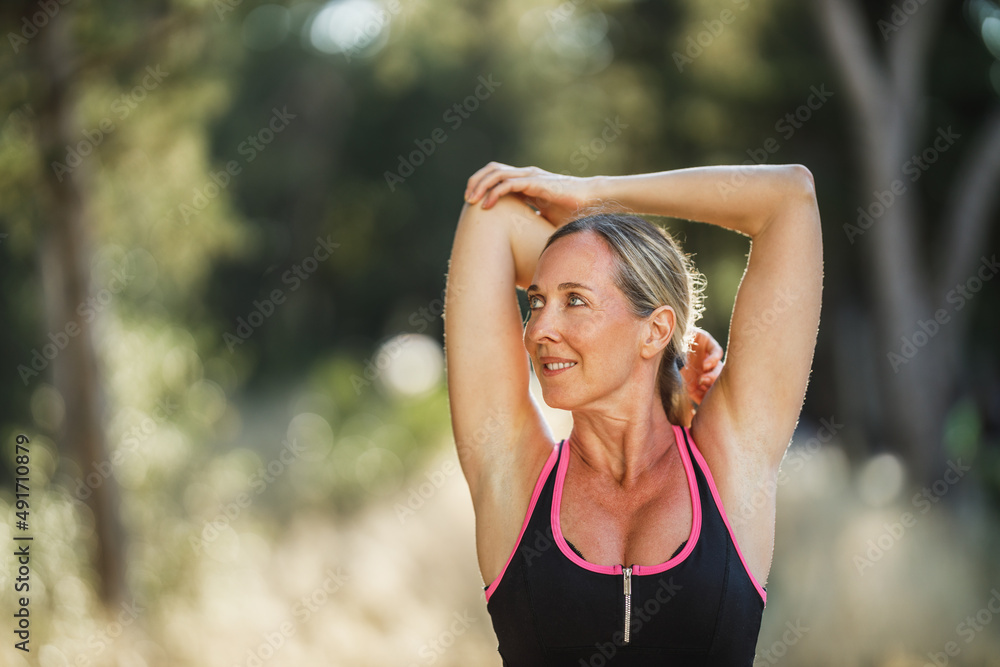 Woman Doing Stretching Exercises During Training In Park At Summer Day Woman Doing Stretching Exercises During Training In Park At Summer Day