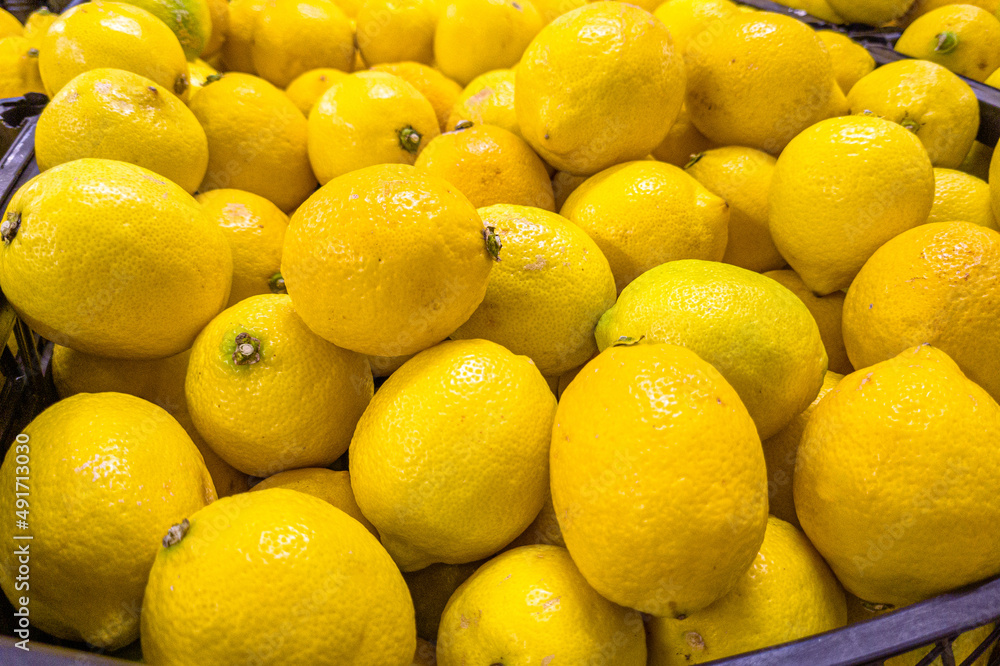 Fresh lemons are in a drawer in the store