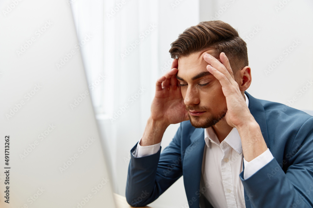 handsome businessman at the desk in the office an official Gray background handsome businessman at the desk in the office an official Gray background
