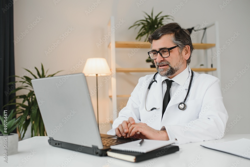 Remote medical consultation. A male doctor consults a woman has a video call conference computer monitor sitting in a clinic office. Remote medical consultation. A male doctor consults a woman has a video call conference computer monitor sitting in a clinic office.