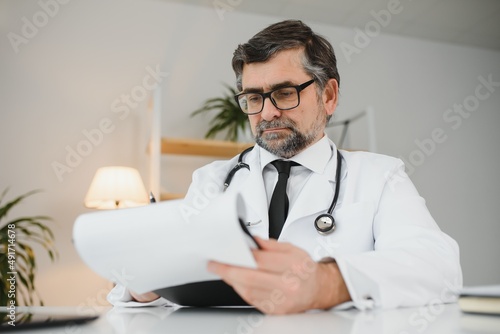 Portrait of senior doctor sitting in medical office