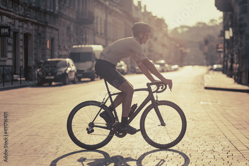 Active man riding bike on street during morning time