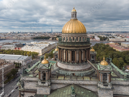 Cropped aerial photo of Saint Isaacs Cathedral in Saint Petersburg. Large orthodox church with golden dome and colonnade. Travel destination. Cloudy sky. Vacation concept.