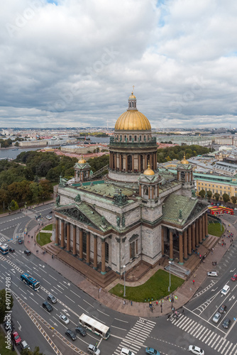Vertical aerial photo of Saint Isaacs Cathedral in Saint Petersburg. Large orthodox church with golden dome and colonnade. Travel destination. Cloudy sky. Vacation concept.