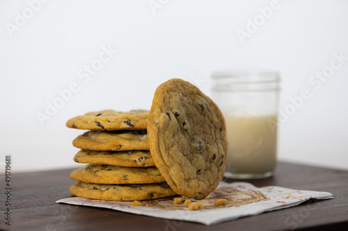 фотографія a stack of homemade chocolate chip cookies with a glass of milk
