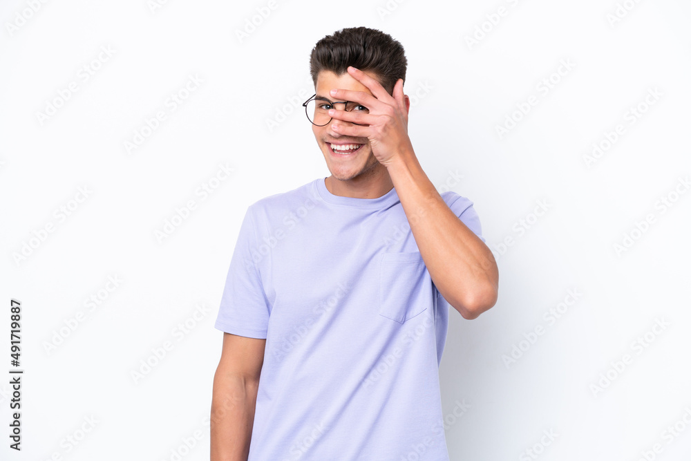 Young caucasian man isolated on white background covering eyes by hands and smiling Young caucasian man isolated on white background covering eyes by hands and smiling