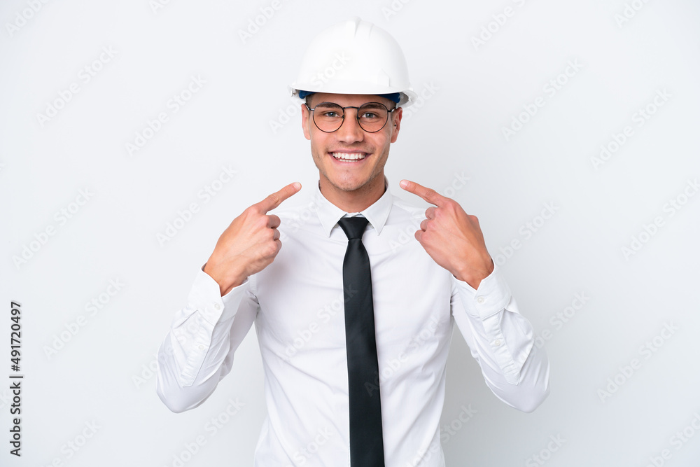 Young architect caucasian man with helmet and holding blueprints isolated on white background giving a thumbs up gesture Young architect caucasian man with helmet and holding blueprints isolated on white background giving a thumbs up gesture