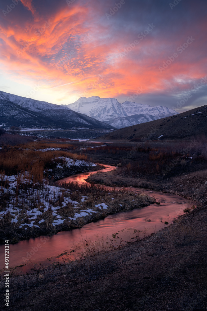 Burning snowy mountain sunset with stream over Mt Timpanogos in Heber Valley, Utah