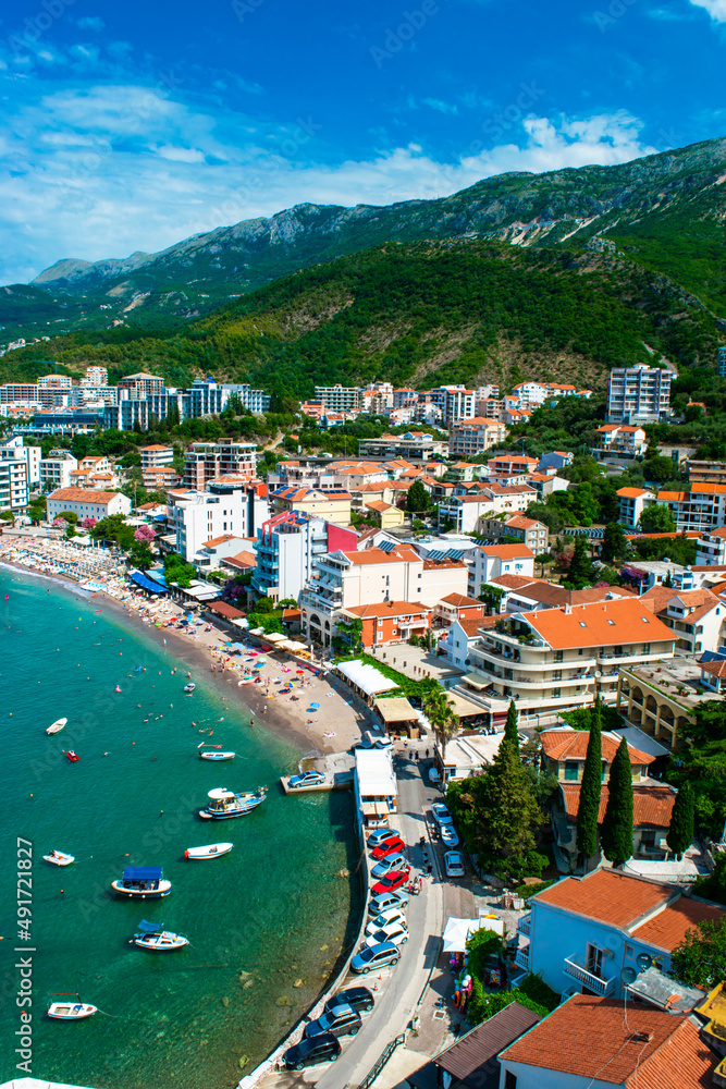 Panorama of the beach and the resort towns of Becici and Rafailovici, located at the foot of the mountains. Montenegro.