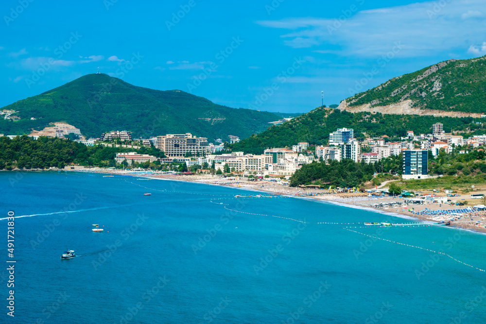 Panorama of the beach and the resort towns of Becici and Rafailovici, located at the foot of the mountains. Montenegro.