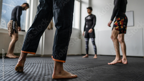 Close up on leg of unknown man at brazilian jiu jitsu bjj training copy space martial arts concept