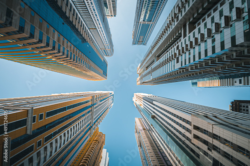 Photography Modern glass skyscrapers in Dubai with blue sky in background