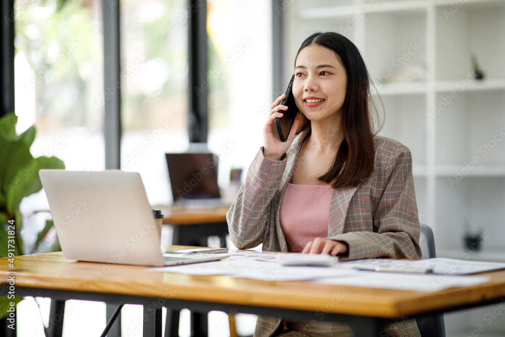 Asian young businesswoman working in the office with laptop computer, doing planning analyzing the financial report, business plan investment, finance analysis concept Asian young businesswoman working in the office with laptop computer, doing planning analyzing the financial report, business plan investment, finance analysis concept